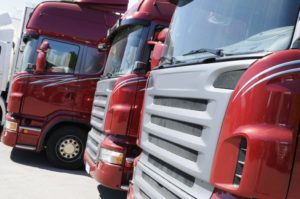 Red commercial trucks in a line