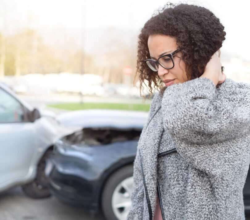 Woman suffering from a whiplash injury after a car accident